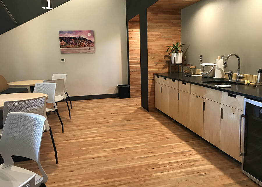 The large break room featuring nail laminated time floors and wall accents